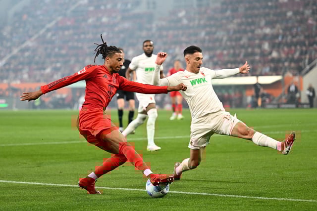 Soccer Football - Bundesliga - FC Augsburg v Bayern Munich - WWK Arena, Augsburg, Germany - April 4, 2025 Bayern Munich's Michael Olise in action with FC Augsburg's Cedric Zesiger REUTERS/Angelika Warmuth