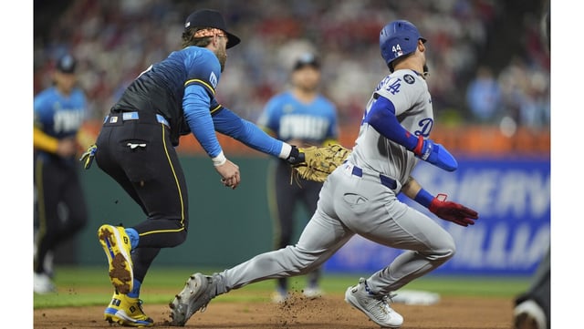 Philadelphia Phillies first baseman Bryce Harper, left, tags out the Dodgers’ Andy Pages during a rundown in the sixth inning on Friday night in Philadelphia. The Dodgers lost for the first time in nine games this season, 3-2. (AP Photo/Matt Rourke)