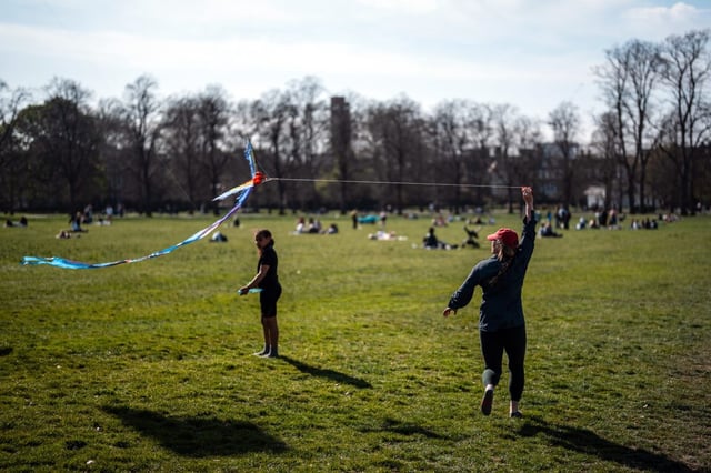 A woman flies a kite in Greenwich Park on Friday. (Photo: Carl Court/Getty Images)
