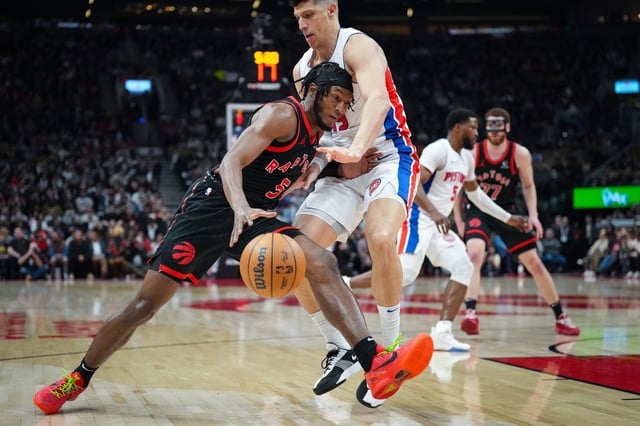 Toronto Raptors guard Immanuel Quickley (5) drives into Detroit Pistons forward Simone Fontecchio (19) during first half NBA basketball action in Toronto on Friday, April 4, 2025. THE CANADIAN PRESS/Arlyn McAdorey