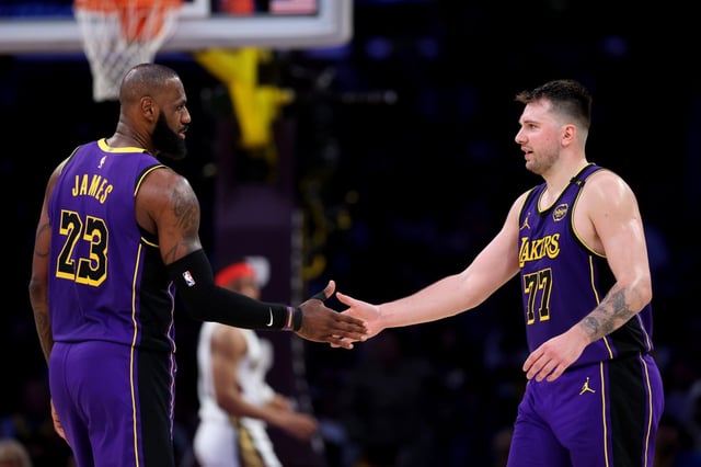 Lakers stars LeBron James, left, and Luka Doncic celebrate a play during the first half of their victory over the New Orleans Pelicans on Friday night at Crypto.com Arena. (Photo by Luke Hales/Getty Images)