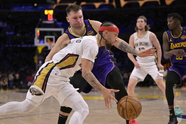 Apr 4, 2025; Los Angeles, California, USA;  New Orleans Pelicans guard Jose Alvarado (15) drives past Los Angeles Lakers guard Luka Doncic (77) in the second half at Crypto.com Arena. Mandatory Credit: Jayne Kamin-Oncea-Imagn Images