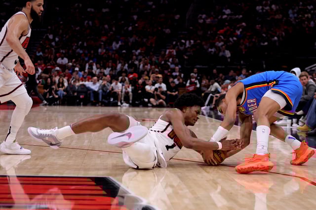 Apr 4, 2025; Houston, Texas, USA; Houston Rockets guard Amen Thompson (1) and Oklahoma City Thunder guard Aaron Wiggins (21) both pursue a loose ball during the fourth quarter at Toyota Center. Mandatory Credit: Erik Williams-Imagn Images