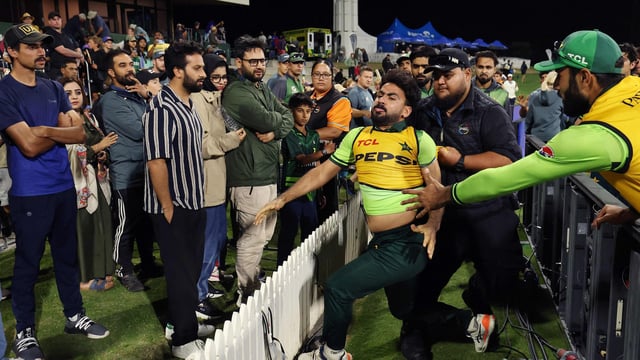 Pakistan's Khushdil Shah is held back after reacting to comments from the crowd during the third ODI. 