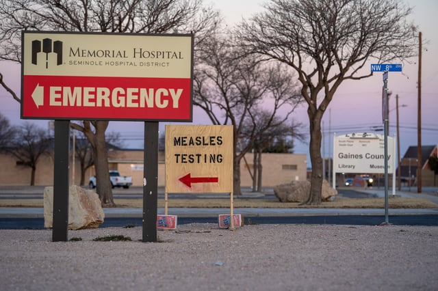Signs point the way to measles testing on February 27 in Seminole, Texas.
