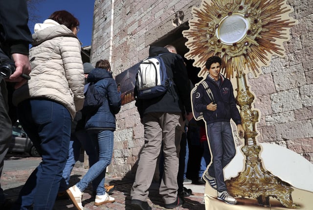 Pilgrims queue to enter the Church of Santa Maria Maggiore and Sanctuary of the Renunciation and to pay their respects at the tomb of the Blessed Carlo Acutis in on March 18, 2025 in Assisi, Italy.