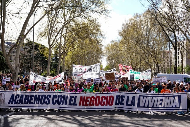 People hold a banner as they take part in a protest to demand lower housing rental prices and better living conditions, in Madrid, Spain, April 5, 2025. REUTERS/Ana Beltran
