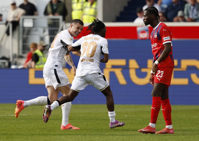 Soccer Football - Bundesliga - 1. FC Heidenheim v Bayer Leverkusen - Voith-Arena, Heidenheim, Germany - April 5, 2025 Bayer Leverkusen's Granit Xhaka and Jeremie Frimpong celebrate after Emiliano Buendia scores their first goal