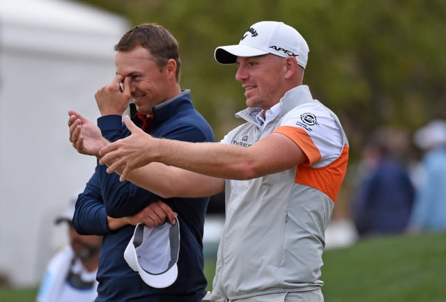 Jordan Spieth and Matt Wallace of England talk on the 18th green during the third round of Valero Texas Open at TPC San Antonio Oaks Course on April 03, 2021 in San Antonio, Texas.