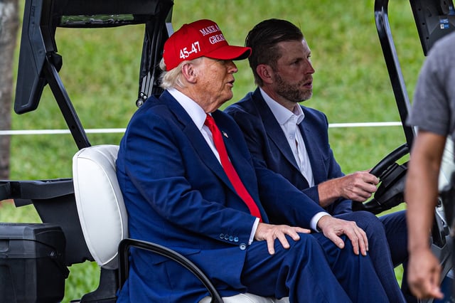 U.S. President Donald Trump and his son Eric Trump drive in a golf cart after arriving in Marine One on the ninth hole during previews for LIV Golf Miami at Trump National Doral Miami on April 03, 2025 in Doral, Florida.