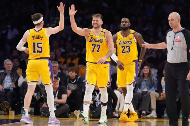 Lakers guard Luka Doncic, center, is congratulated after scoring by Austin Reaves, left, as LeBron James follows during the second half against the Minnesota Timberwolves on Thursday, Feb. 27, 2025, at Crypto.com Arena. (AP Photo/Mark J. Terrill)
