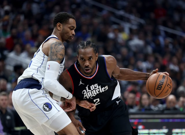 Kawhi Leonard #2 of the LA Clippers drives to the basket on P.J. Washington #25 of the Dallas Mavericks during the first half at Crypto.com Arena on April 23, 2024 in Los Angeles, California. User is consenting to the terms and conditions of the Getty Images License Agreement.