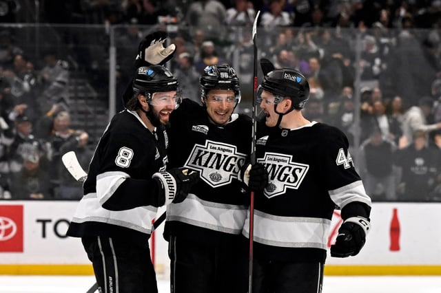 Kings defensemen Drew Doughty (8) and Mikey Anderson (44) celebrate after a goal by left wing Andrei Kuzmenko (96) against the Edmonton Oilers during the second period of an NHL hockey game in Los Angeles, Saturday, April 5, 2025. (AP Photo/Alex Gallardo)