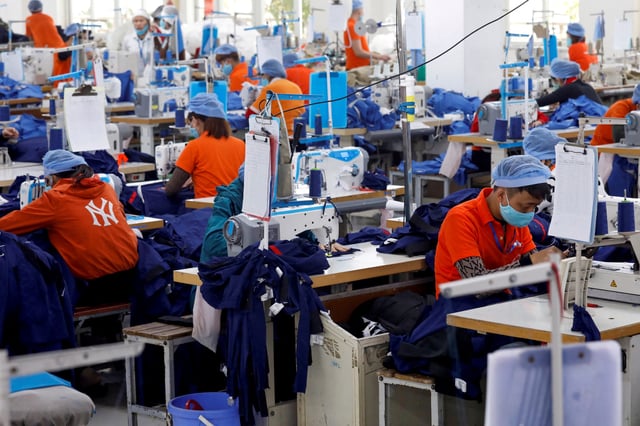 Labourers work at Hung Viet garment export factory in Hung Yen province, Vietnam December 30, 2020. REUTERS/Kham/File Photo