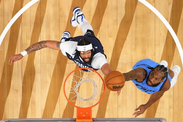 Clippers forward Kawhi Leonard, right, shoots as Dallas Mavericks forward Anthony Davis defends during the first half of an NBA basketball game Saturday, April 5, 2025, in Inglewood, Calif. (AP Photo/Mark J. Terrill)