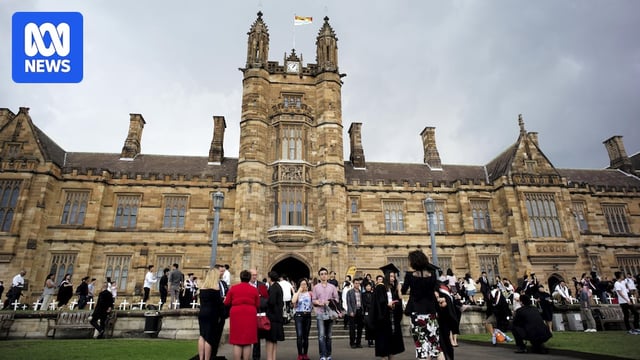 University students walk on the campus of University of Sydney following a graduation ceremony in Sydney.