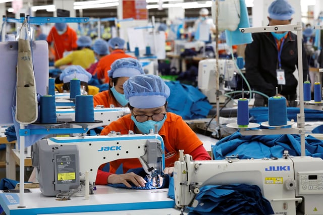 Labourers work at Hung Viet garment export factory in Hung Yen province, Vietnam December 30, 2020. REUTERS/Kham/File Photo