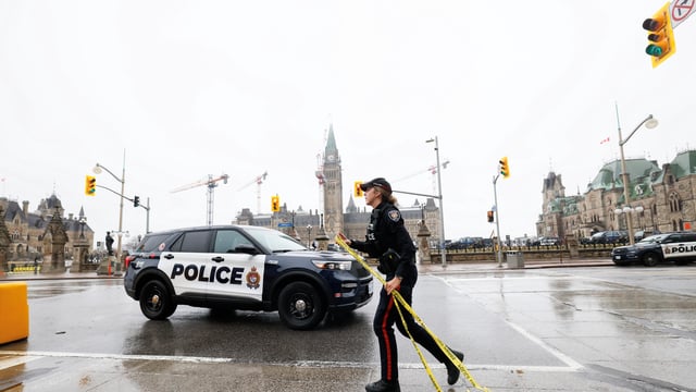 A police officer secures the perimeter of Canada's Parliament after declaring a lockdown, in Ottawa, Ontario, Canada, April 5, 2025. 