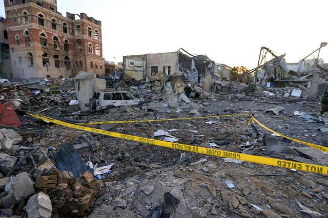 Men check the damages in an area struck by a US airstrike in Houthi-controlled Sanaa, Yemen on March 20.