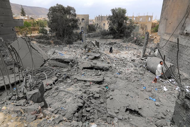 A man stands amidst the rubble of a collapsed building at the site of a reported US air strike on Yemen's Houthi-held capital Sanaa on March 24.