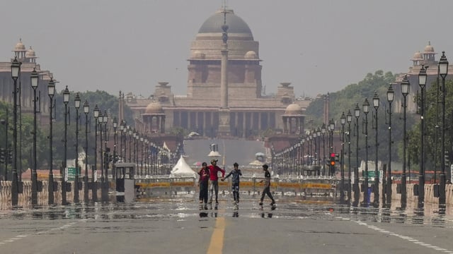 Heatwave in Delhi: Visitors take a walk on Kartavya Path as a mirage appears on a hot summer day, in New Delhi, Sunday, April 6, 2025.