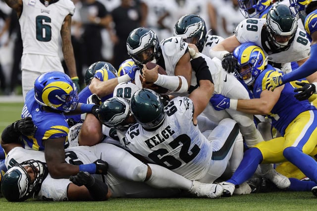 Philadelphia Eagles quarterback Jalen Hurts (with ball) stretched but was unable to get a first down on a tush push play during the second half against the Los Angeles Rams last season.