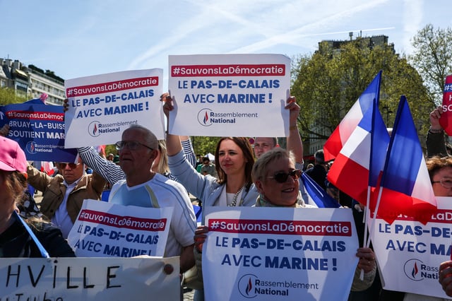 People attend a rally in support of French far-right leader Marine Le Pen, after calls for a peaceful mobilisation following Marine Le Pen's conviction for embezzlement of EU funds, resulting in her being barred from running for office for five years, in Paris, France, April 6, 2025. REUTERS/Gonzalo Fuentes