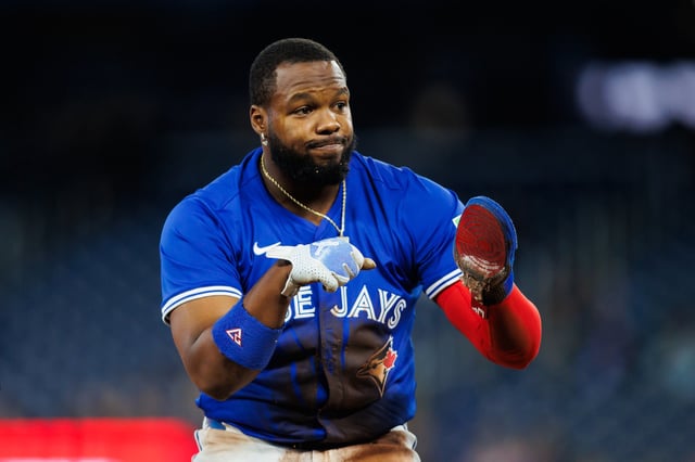 Vladimir Guerrero Jr. #27 of the Toronto Blue Jays reacts after sliding safely into third base as he advances on a pop-fly from teammate Andrés Giménez #0 in the first inning of their MLB game against the Baltimore Orioles at Rogers Centre on March 29, 2025 in Toronto, Ontario, Canada.