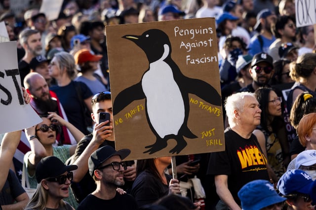 A protester holds a sign during the nationwide &#34;Hands Off!&#34; protest against US President Donald Trump and his advisor, Tesla CEO Elon Musk, in downtown Los Angeles on April 5, 2025.