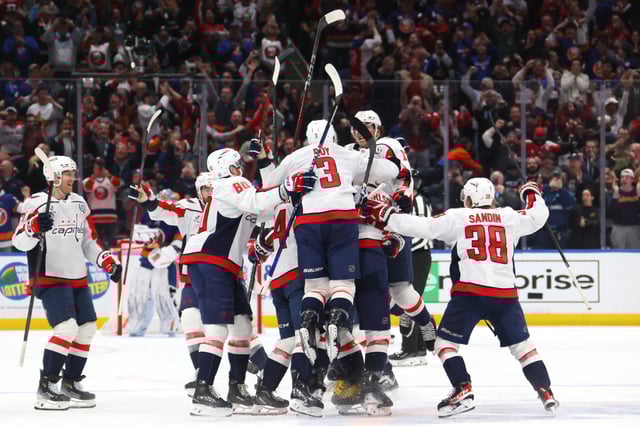 Alex Ovechkin #8 of the Washington Capitals celebrates with teammates after scoring his 895th career goal during the second period against the New York Islanders to become the NHL all-time goals leader at UBS Arena on April 06, 2025 in Elmont, New York.