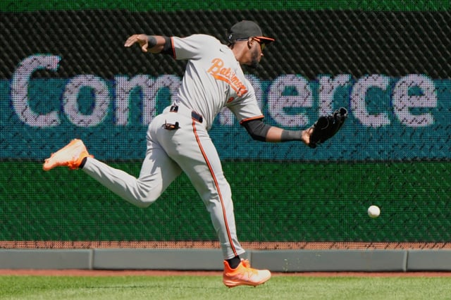 Baltimore Orioles center fielder Jorge Mateo fields a triple hit by Kansas City Royals&#39; Bobby Witt Jr. during the first inning of a baseball game, Sunday, April 6, 2025, in Kansas City, Mo. (AP Photo/Charlie Riedel)