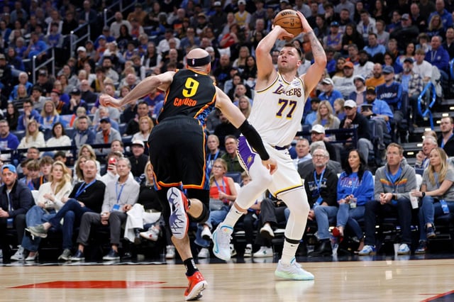 Lakers guard Luka Doncic (77) looks to shoot over Oklahoma City Thunder guard Alex Caruso (9) during the first half of an NBA basketball game Sunday, April 6, 2025, in Oklahoma City. (AP Photo/Nate Billings)