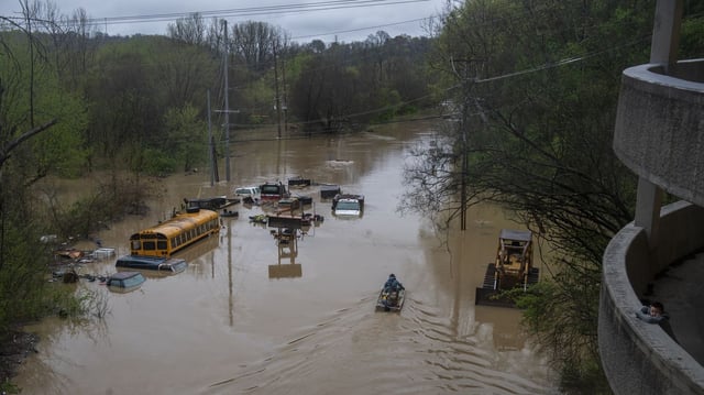 A boy looks out from a parking garage as two people on take a boat into the flood waters on April 6, 2025 in Frankfort, Kentucky. Frankfort was expected to experience record flooding as the Kentucky River continued to rise. Photo: Michael Swensen/Getty Images