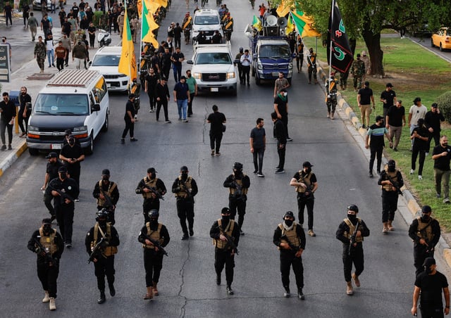 A vehicle carries the coffin of a commander from Iraq's Kataib Hezbollah armed group who was killed in what they called a "Zionist attack" in the Syrian capital Damascus on Friday, during a funeral in Baghdad, Iraq September 22, 2024. REUTERS/Thaier Al-Sudani/File Photo