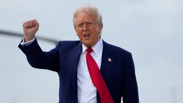 US President Donald Trump gestures as he disembarks Air Force One in Miami, Florida, US, April 3, 2025.