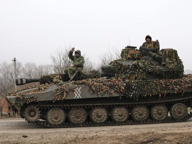 Russian soldiers ride on a self-propelled gun in Kursk.