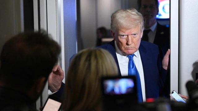 US President Donald Trump speaks to reporters while in flight on Air Force One, en route to Joint Base Andrews on April 6, 2025.