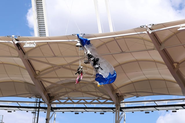 The parachutist dangled above the stands until being rescued by the fire service.
