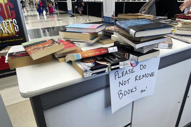 FILE - Banned books are stacked at an exhibit at the American Library Association's annual conference, June 24, 2023, at McCormick Place in Chicago. (AP Photo/Claire Savage, File)