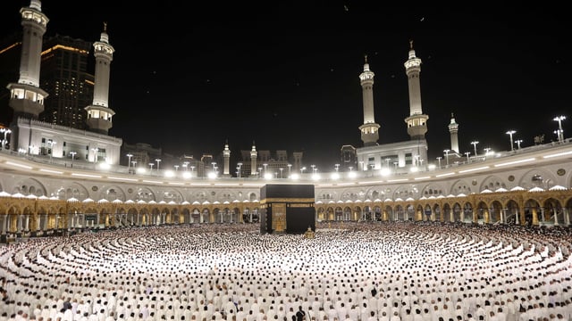Muslims perform the morning prayer around the Kaaba at the Grand Mosque in Saudi Arabia's holy city of Mecca at the start of Eid al-Fitr, which marks the end of the Muslim holy fasting month of Ramadan, early on March 30, 2025. 