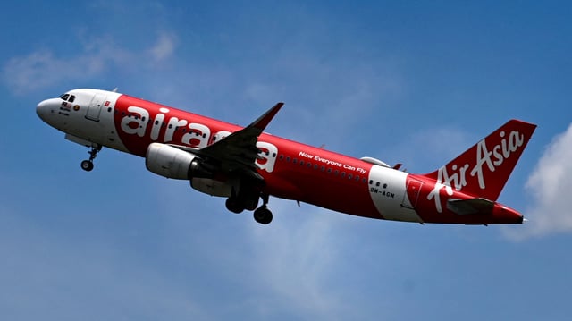 An AirAsia passenger plane takes off.