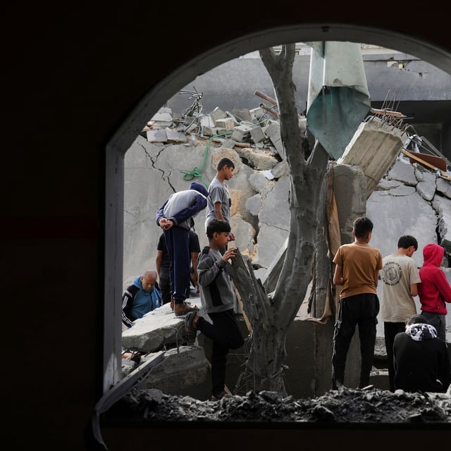 Palestinians inspect the site hit by an Israeli strike in Deir al-Balah, Gaza Strip on Monday, April 7, 2025. (AP Photo/Abdel Kareem Hana)