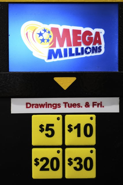 A Mega Millions lottery ticket vending machine is seen at a convenience store in Chicago, Sunday, April 6, 2025. (AP Photo/Nam Y. Huh)