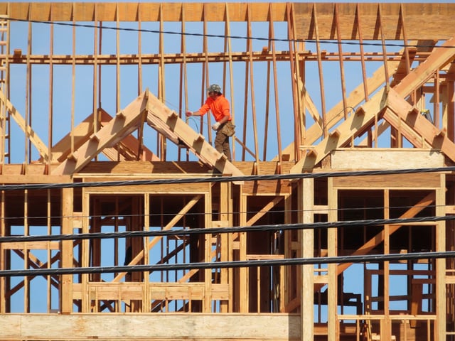 A construction worker examines part of a building under construction in Brick, N.J. on July 10, 2023.