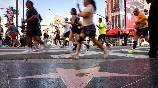 Runners pass by the stars along Hollywood Blvd during the 40th LA Marathon on Sunday, March 16, 2025.  Thousands of runners hit the pavement from Dodger Stadium to Century City in the 40th running of the marathon. (Photo by David Crane, Los Angeles Daily News/SCNG)