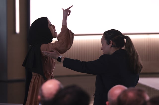 CORRECTS DATE - A pro-Palestinian demonstrator, Ibtihal Aboussad, is escorted away by security as they interrupt Microsoft AI CEO Mustafa Suleyman during a presentation of the company's AI assistant, Copilot, ahead of a 50th Anniversary presentation at Microsoft headquarters, Friday, April 4, 2025, in Redmond, Wash. (AP Photo/Jason Redmond)