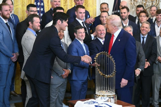 US President Donald Trump congratulates Shohei Ohtani as he receives the Los Angeles Dodgers baseball team at a White House event