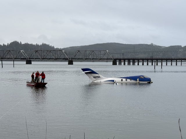 A business jet sits in the water 100 feet past the end of the runway at Southwest Oregon Regional Airport where it skidded off the runway around 6 a.m. local time Monday morning.
