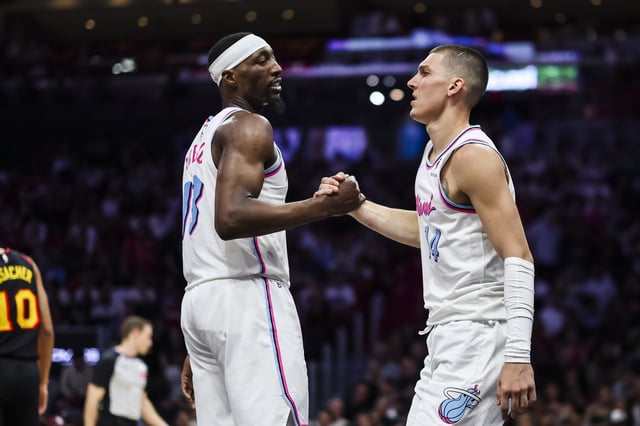 Bam Adebayo (L) #13 of the Miami Heat and Tyler Herro #14 of the Miami Heat reacts during the fourth quarter against the Atlanta Hawks at Kaseya Center on March 27, 2025 in Miami, Florida. Find out if the Heat&#39;s top two players will be on the court against the 76ers on Monday.