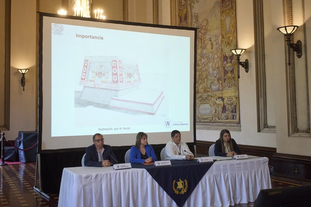 An illustration of a Teotihuacan-style altar that was recently discovered in the Mayan site of Tikal is displayed on a screen as Guatemalan archaeologist Lorena Paiz, right, speaks during a press conference at the National Palace in Guatemala City, Monday, April 7, 2025. (AP Photo/Moises Castillo)